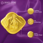 Close-up of the Lakshmi shankh-shaped gold coin with embossed artwork and mirror-like finish.